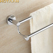 Modern chrome double towel bar with sleek design mounted on beige wall for bathroom towel organization