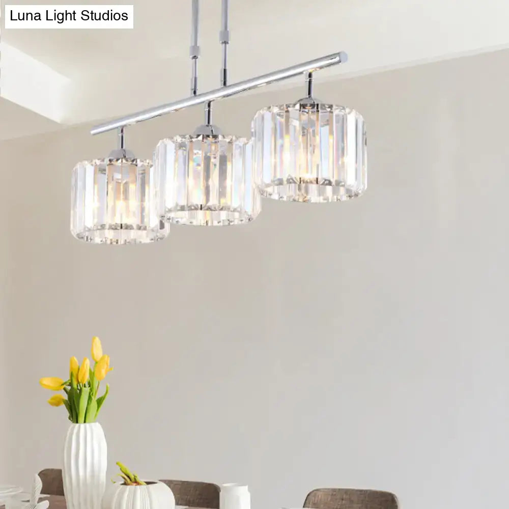 Modern chrome drum pendant light with three cylindrical crystal shades designed for bedroom use