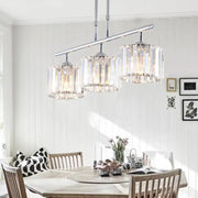 Modern chrome drum pendant light with three cylindrical crystal shades ideal for bedroom lighting