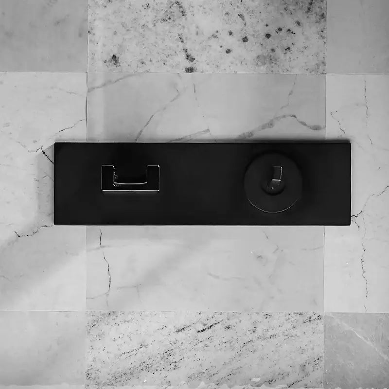Black matte-finish wall-mounted drawer pull with integrated keyhole complementing decorbites basin faucet dual handle design