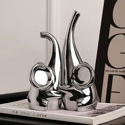 Modern chrome elephant sculpture ceramic bookends with shiny finish and sleek design for living room decor by decorbites