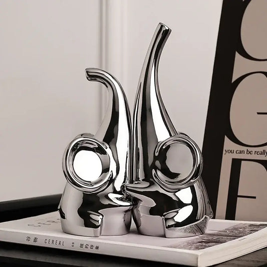 Modern chrome elephant sculpture ceramic bookends with shiny finish and sleek design for living room decor by decorbites