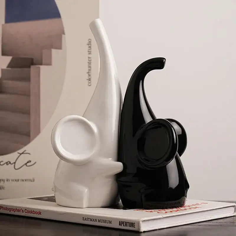 A sleek glossy black ceramic decorbites elephant sculpture bookend with minimalist design for modern living room decor