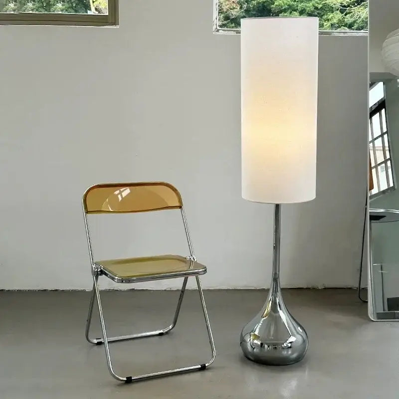 A modern floor lamp with a cream fabric shade and polished chrome base for elegant living room decorbites lighting
