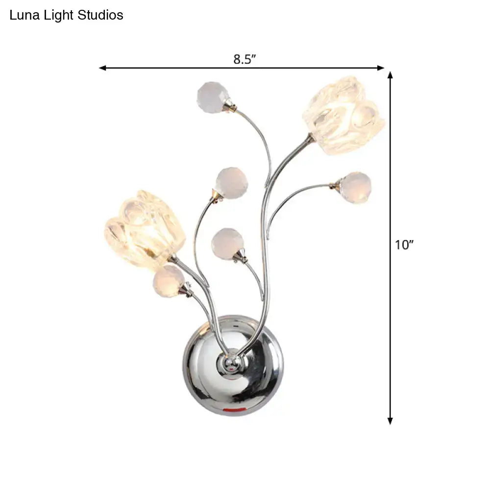 Modern chrome wall lamp with swirling arm and five illuminated glass flower shades for bedroom use