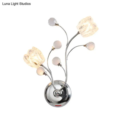 Modern chrome flower shade wall lamp with swirling arm and five illuminated glass flower shades for bedroom use