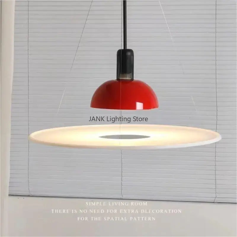 A sleek modern chrome flying saucer chandelier with a glossy red dome and white base for living room lighting