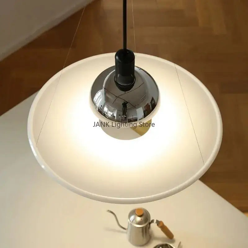 Modern chrome flying saucer chandelier featuring a white pendant lamp with a sleek reflective chrome central fixture