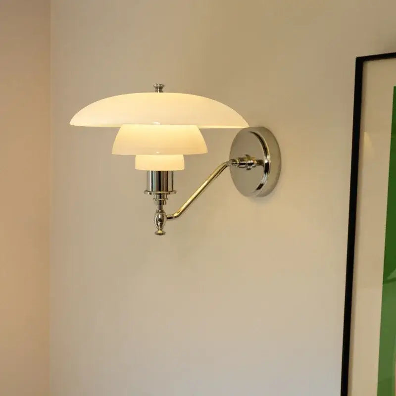 A modern chrome french glass wall lamp with three stacked translucent white shades for bedroom decorbites french glass