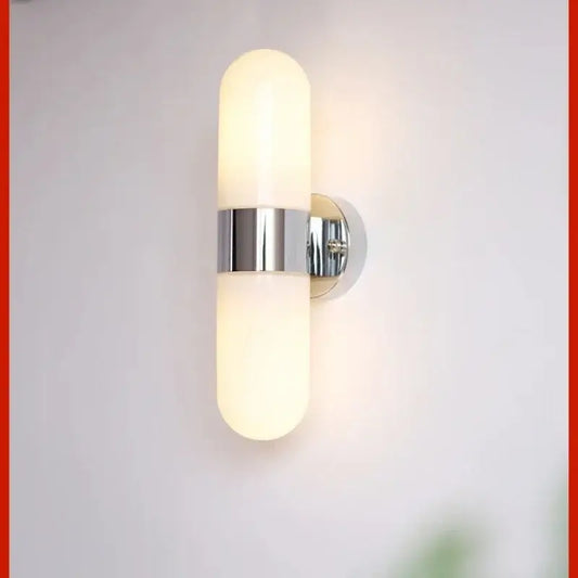 Modern chrome frosted glass vanity mirror light with two cylinders and central metallic band for bathroom use