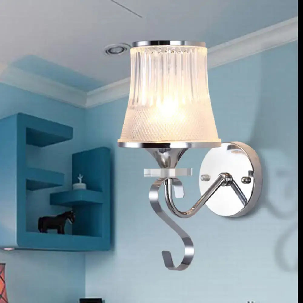 A modern chrome wall light fixture with frosted glass shade and curved arm ideal for bedroom led incandescent fluorescent use