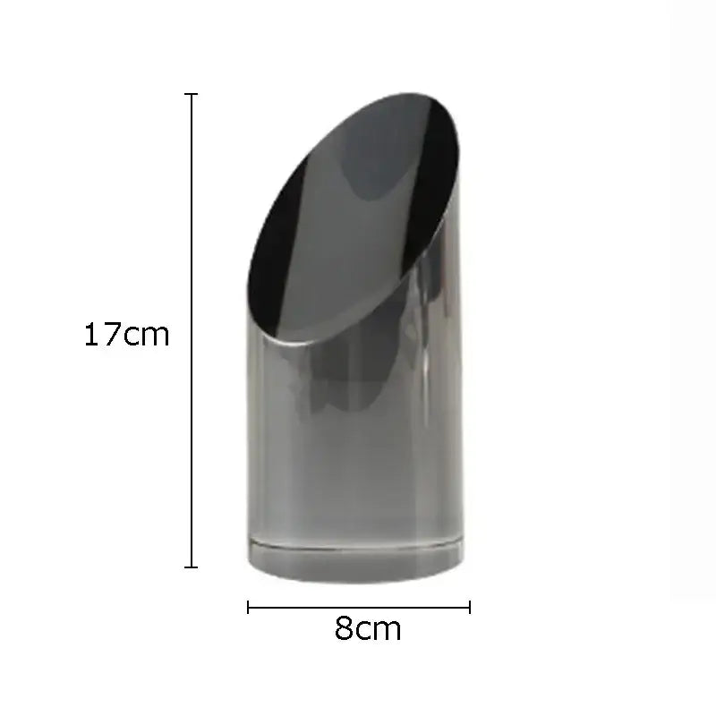 A sleek matte black 17cm tall cylindrical vase complements decorbites geometric crystal artwork polyhedron bookends