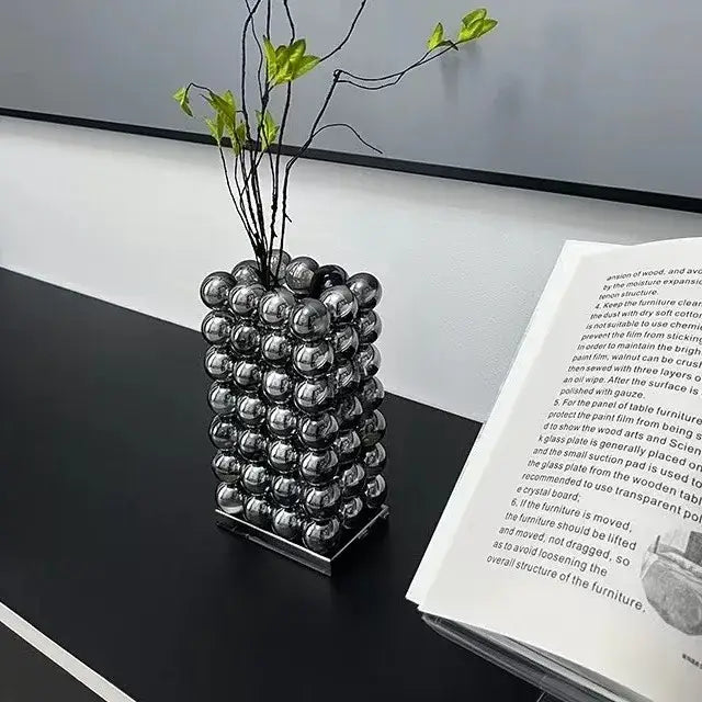 A sleek modern chrome geometric crystal ball glass vase with stacked metallic silver spheres for living room decor