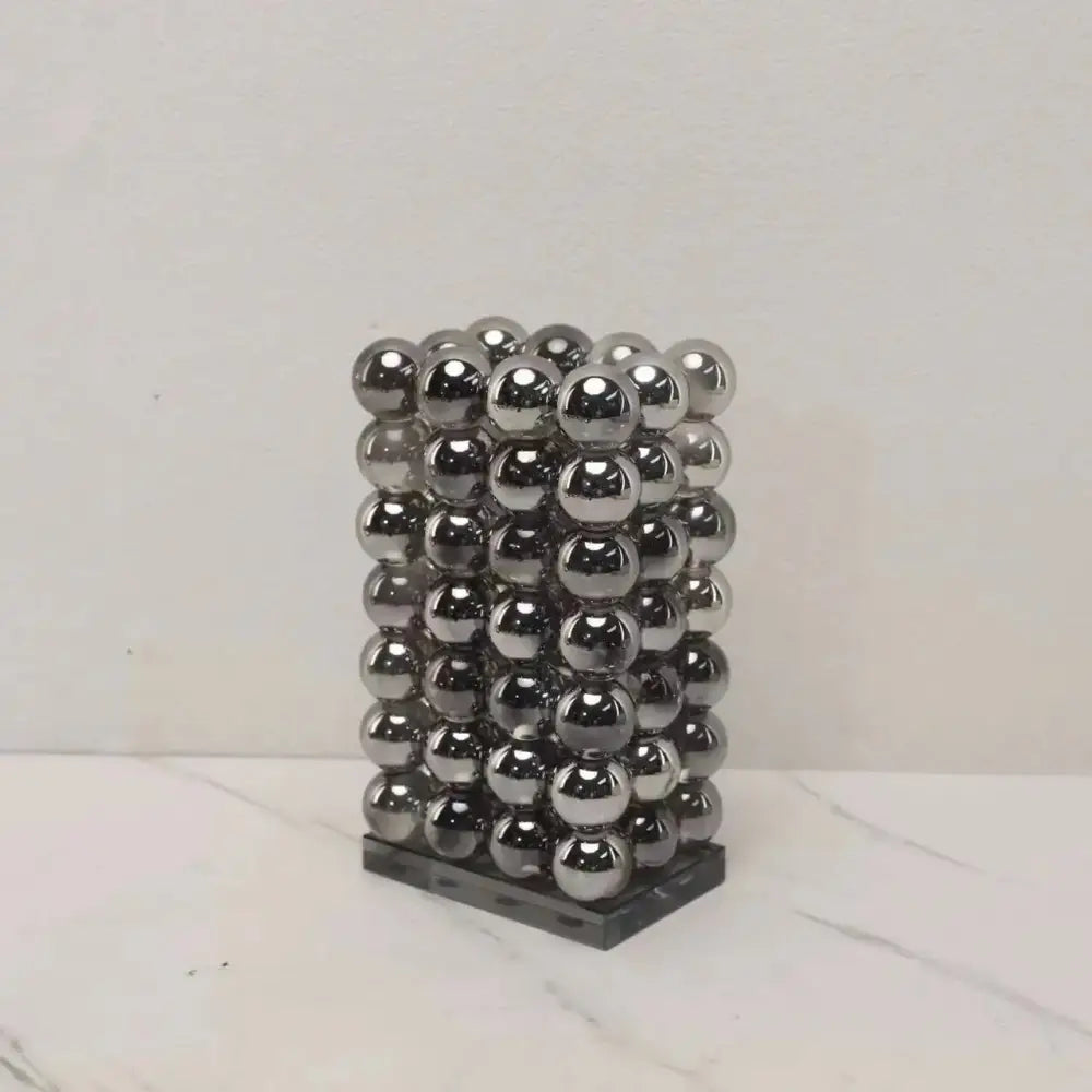 A sleek rectangular modern chrome geometric crystal ball tower made of 36 polished magnetic balls for living room decor