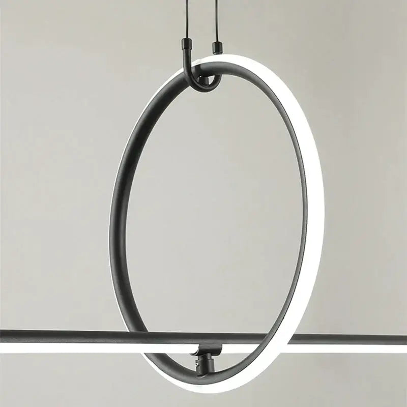 Modern chrome geometric led pendant light featuring a black circular pendant light with glowing white led ring for dining room decorbites geometric led