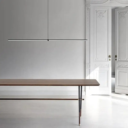 Minimalist black chrome geometric led pendant light from decorbites suspended above wooden dining table