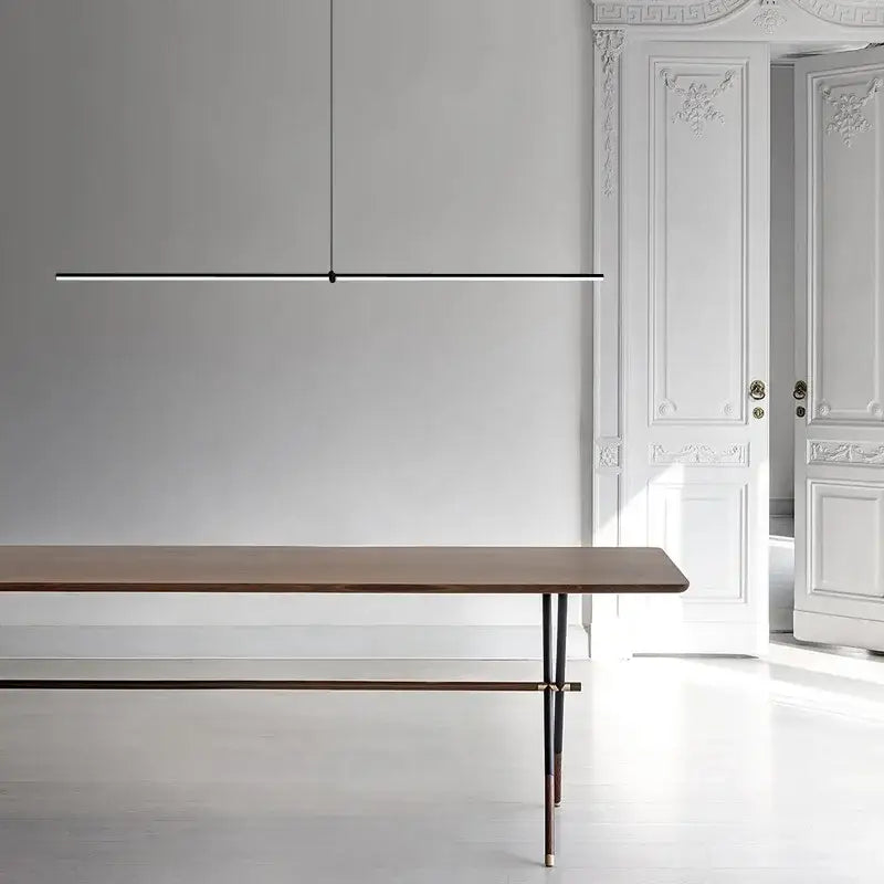 Minimalist black chrome geometric led pendant light from decorbites suspended above wooden dining table