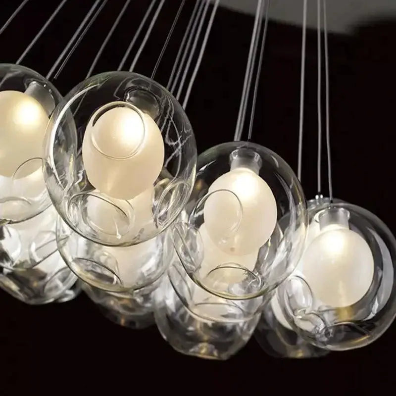 Modern chrome glass ball led chandelier with warm glowing bulbs suspended by thin cables for living and dining rooms