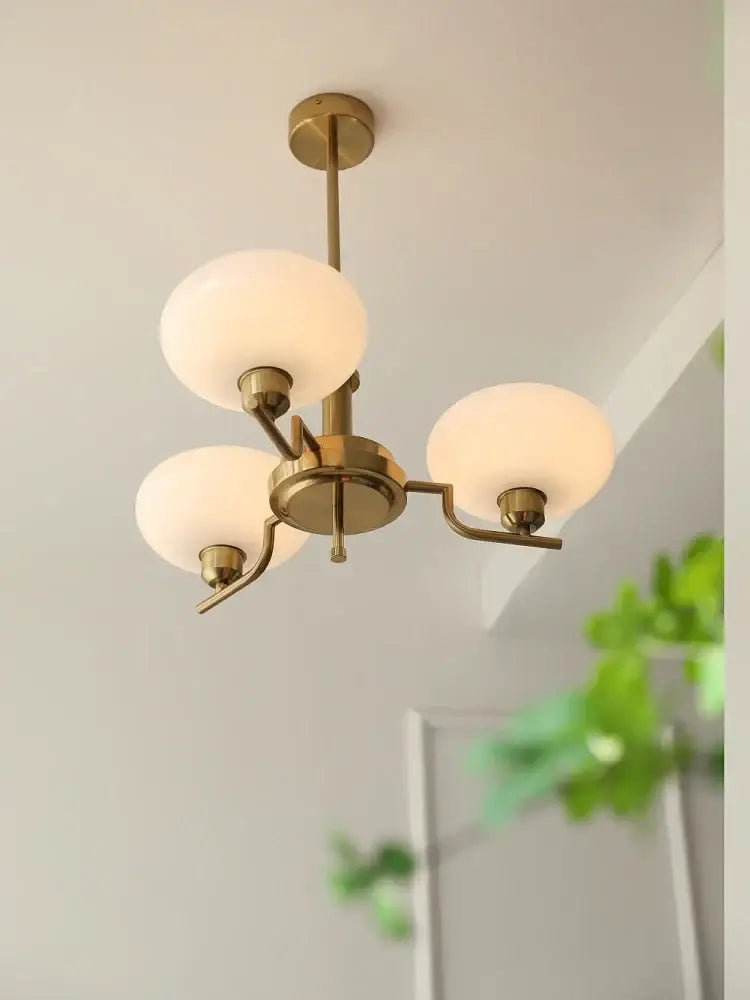 Brass-finished ball pendant chandelier with three frosted glass globe shades for modern bedroom decorbites glass ball design