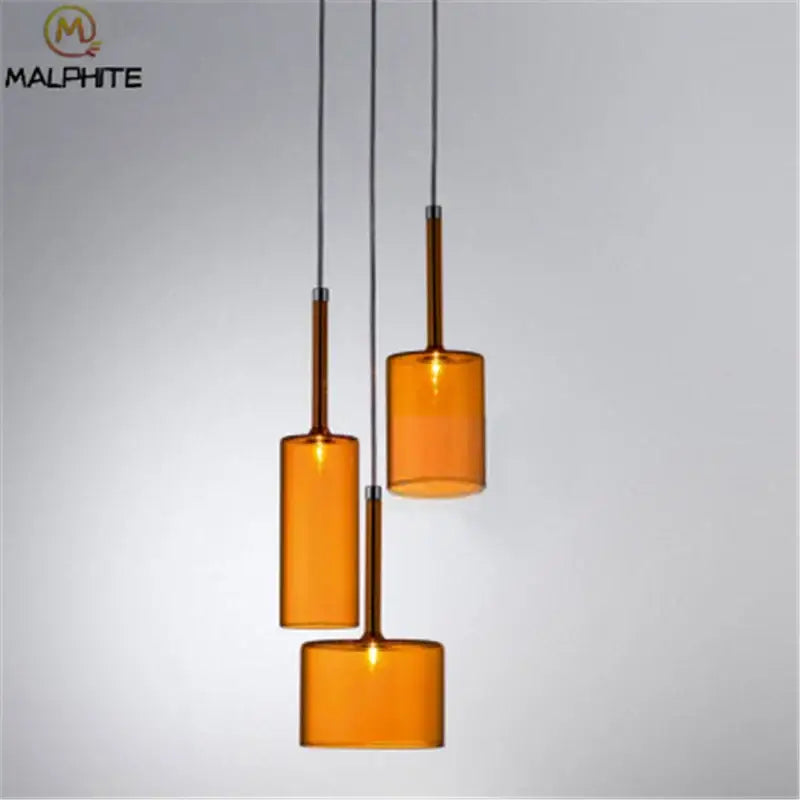 Set of three amber decorbites glass bottle pendant lights with chrome stems for dining room lighting decor