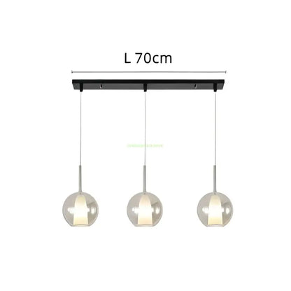 Modern chrome glass bubble pendant lights feature black rectangular bar with three warm glowing glass bubble pendant globes