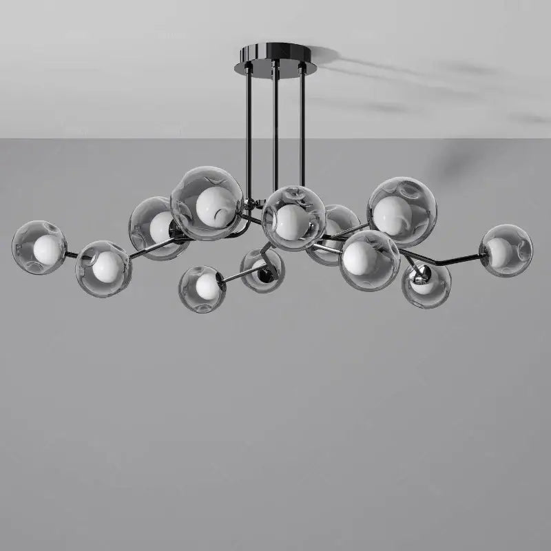 Modern black metal glass globe chandelier with clear glass spheres and exposed globe black LED bulbs for dining room lighting