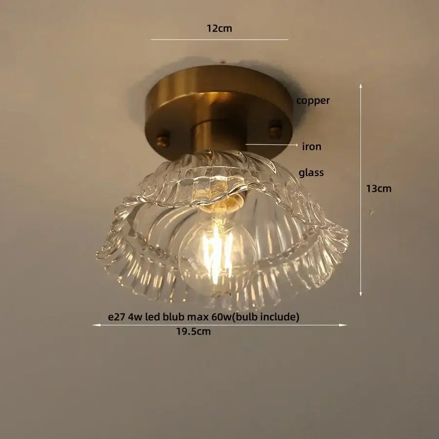 A vintage-style ceiling lamp with brass-finished copper and iron base and scalloped glass led ceiling shade