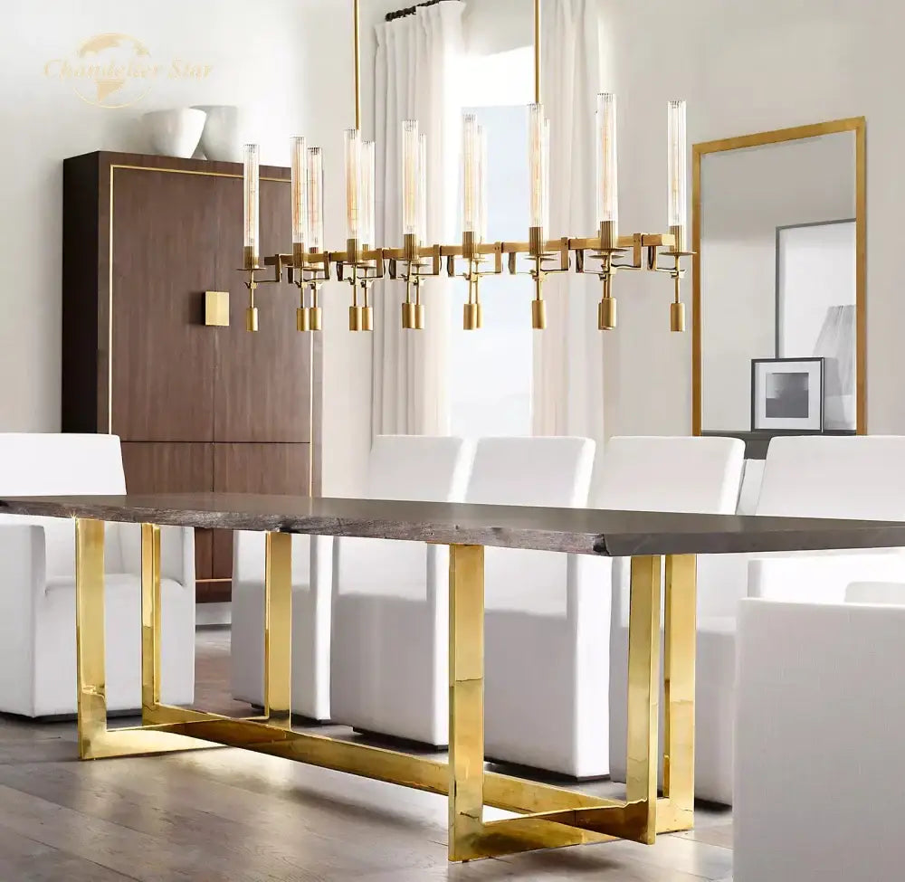 Modern chrome glass led linear chandelier above a gold-toned metal dining table with dark rustic wood top and sleek legs