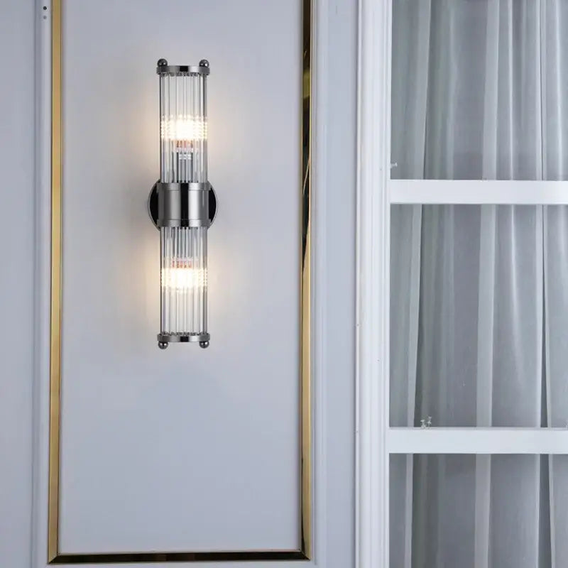 Modern chrome glass rod wall sconce with vertical crystal rods designed as elegant vanity lights for bathrooms
