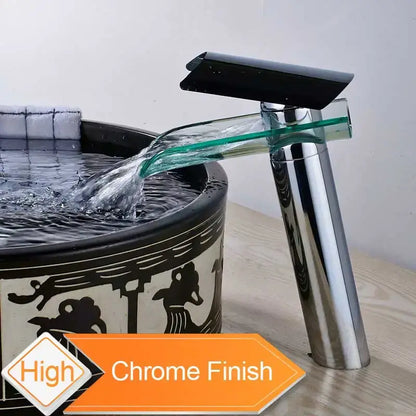 Modern chrome basin faucet with sleek black glass spout and transparent waterfall design for bathroom use