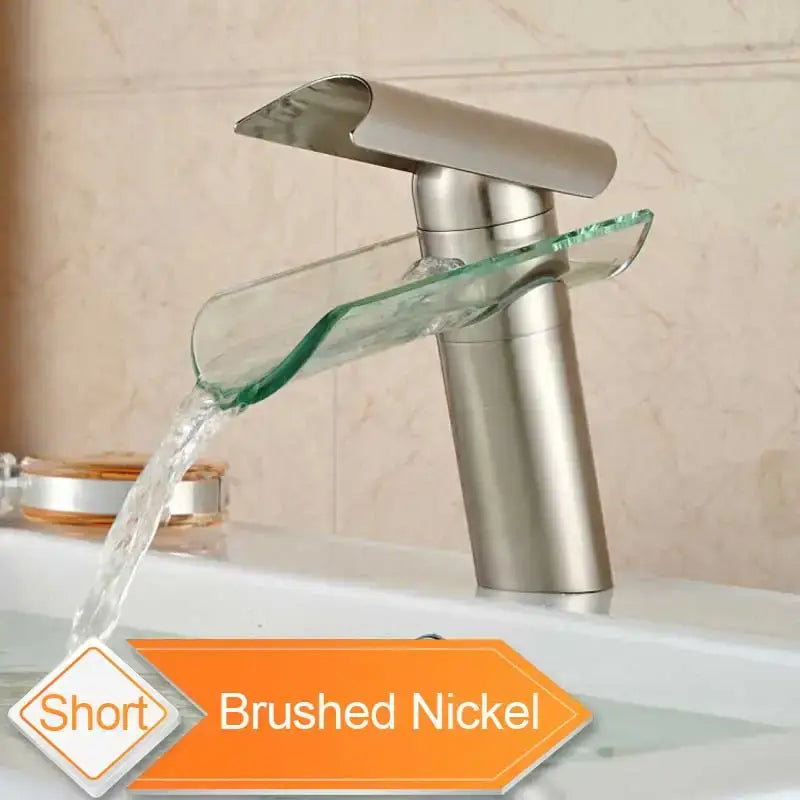Brushed nickel basin faucet with a sleek modern design and curved glass spout waterfall for bathroom use