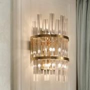 Gold-toned modern chrome gold crystal prism sconce wall lamp with vertical crystal rods and circular metallic bands for living room