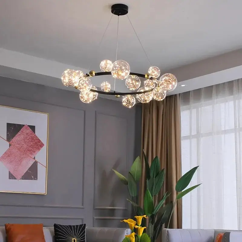 Modern black metal decorbites crystal chandelier with golden accents and clear glass globe bulbs for living room light