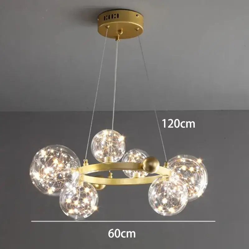 Modern gold-toned decorbites crystal chandelier with clear glass spheres and glowing fairy lights for living room lighting