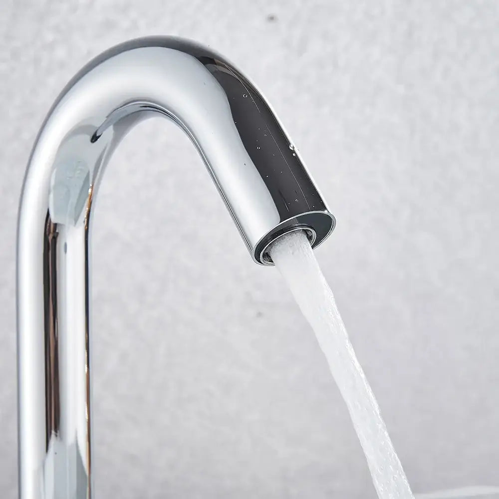 Modern chrome infrared sensor faucet with sleek curved spout and flowing water by decorbites infrared sensor faucet