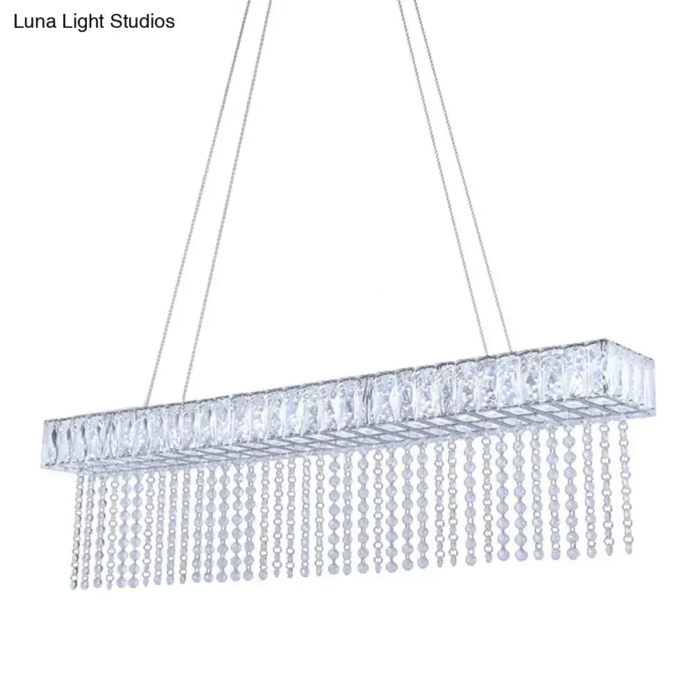 A modern crystal oversized rectangle kitchen island pendant light with clear faceted crystals and cascading bead strands
