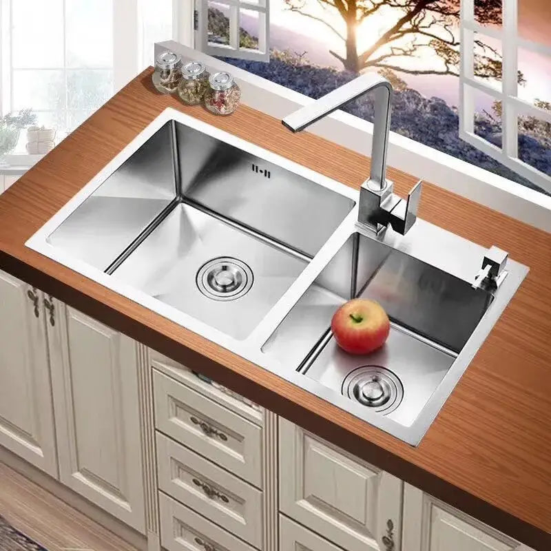Stainless steel double-basin kitchen sink with modern chrome kitchen sink faucet featuring 360 swivel handle