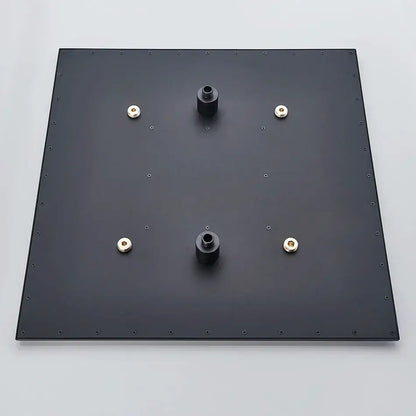 Back side of modern chrome rain shower head with black square mounting plate and gold-colored nuts for ceiling sprayer installation