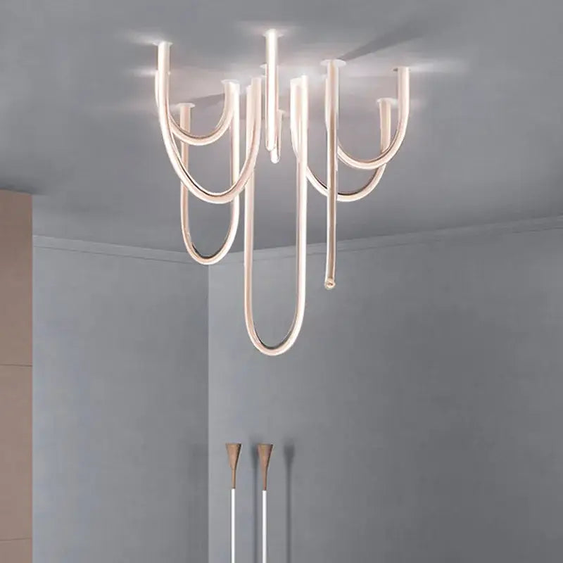 Modern chrome led u shape pendant lamp with sleek curved metallic arms and warm lighting for dining room use