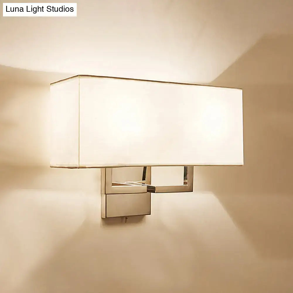 Modern chrome led wall sconce with sleek metal frame and soft white fabric shade for bedroom lighting