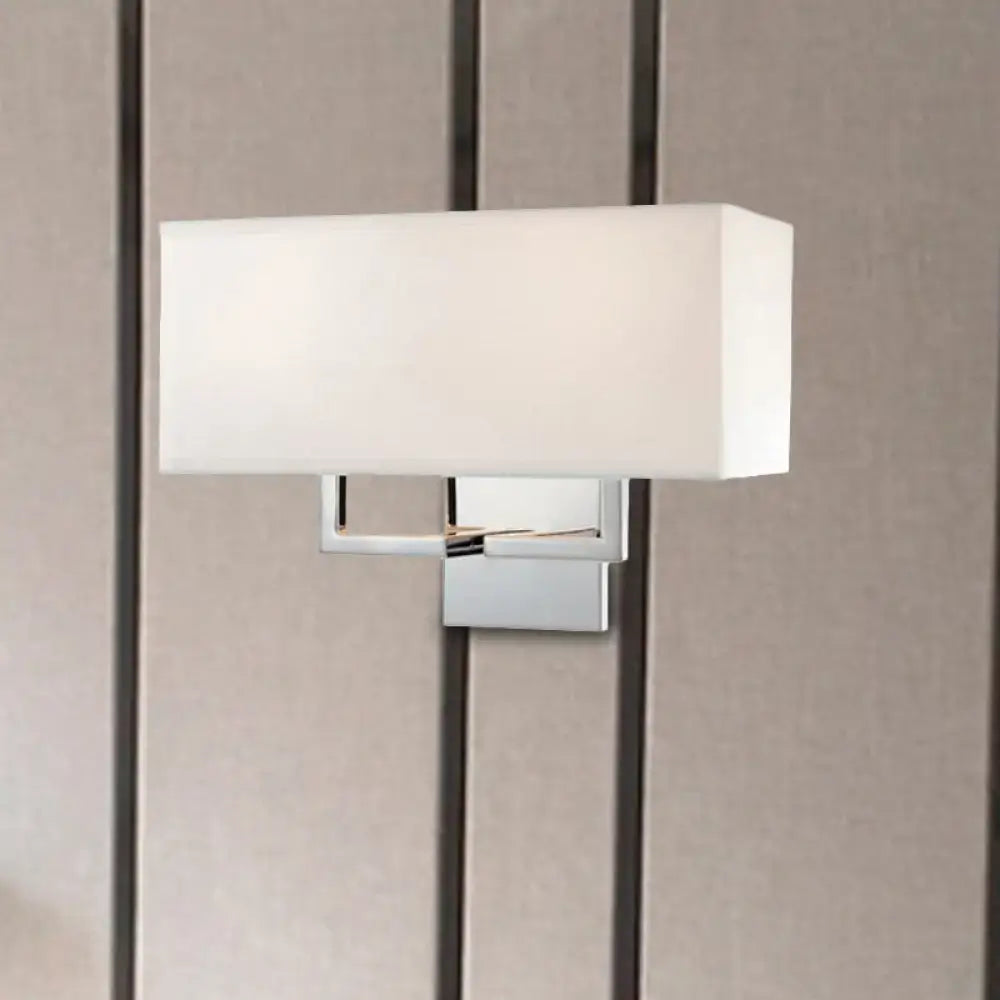 Modern chrome led wall sconce with a sleek chrome finish and white fabric shade for bedroom lighting