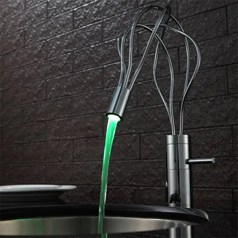 A modern chrome led waterfall bathroom faucet with metallic finish and green light stream by decorbites led waterfall