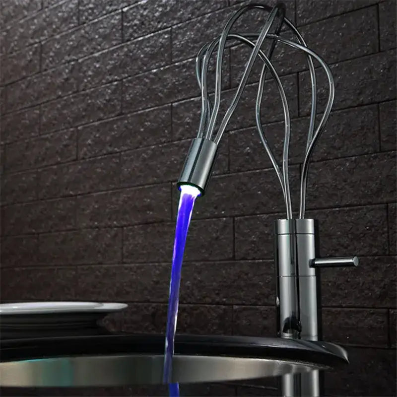 A modern chrome led waterfall bathroom faucet with a metallic finish and blue light stream for decorbites led waterfall