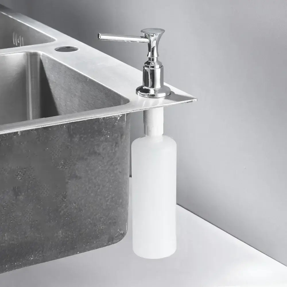 Modern chrome liquid soap dispenser with sleek cylindrical white plastic bottle and lever-style pump for kitchen use