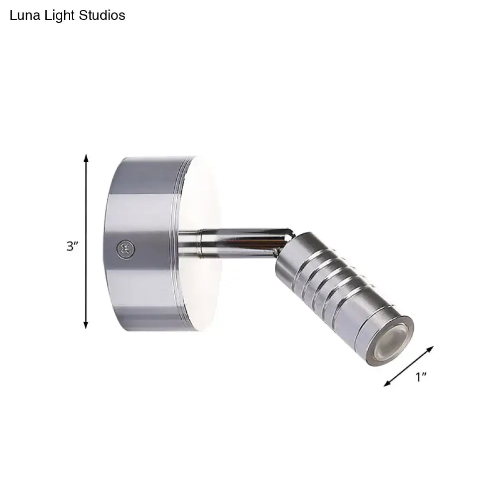 Modern chrome mini tubed wall lamp with adjustable spotlight, cylindrical head, and warm white bathroom lighting