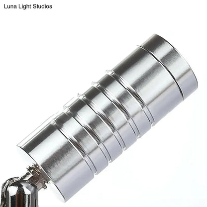 Silver cylindrical magnetic keychain with segmented ribbed design showcasing modern chrome mini tubed wall lamp white warm lighting