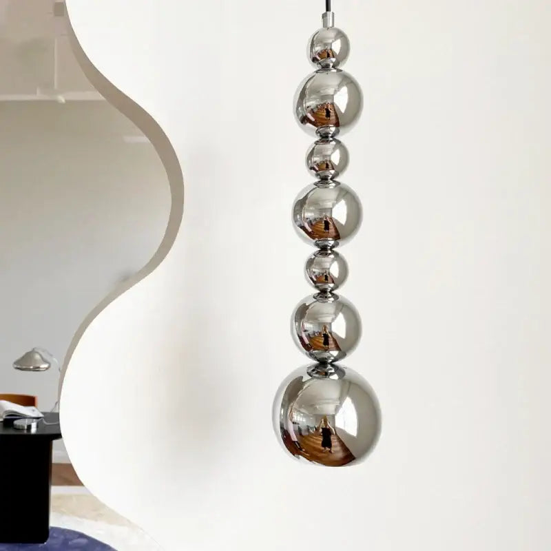Modern chrome multi ball pendant light source with polished chrome spheres stacked vertically for bedroom hanging lamp