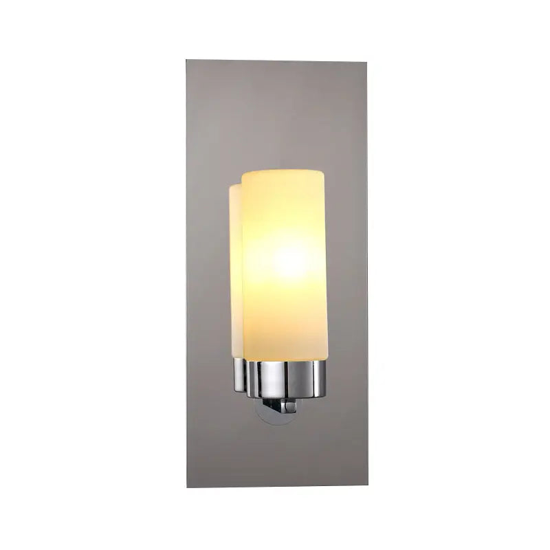 Modern wall light with opal glass tube and polished chrome accents designed as a bedroom sconce with frosted shade