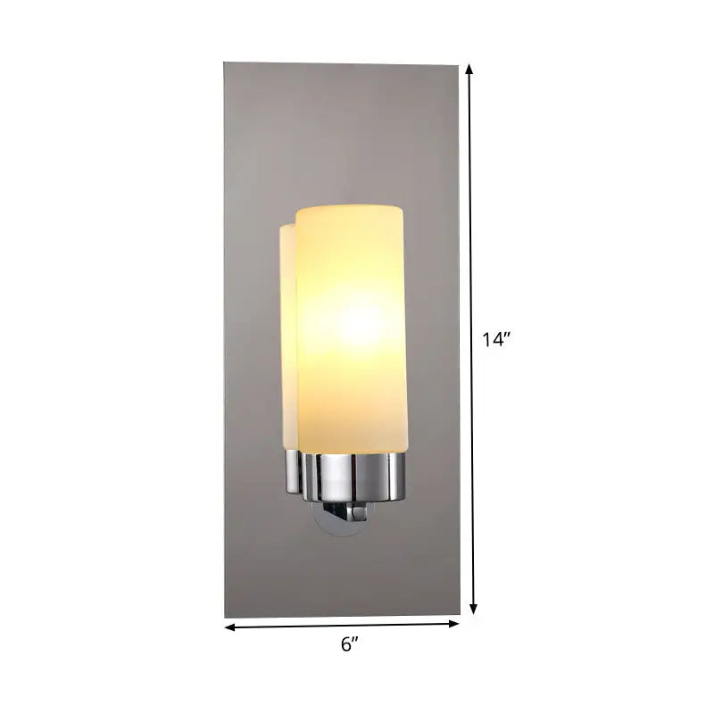 Modern chrome opal glass tube wall light with frosted glass cylindrical shade emitting warm soft light for bedroom use