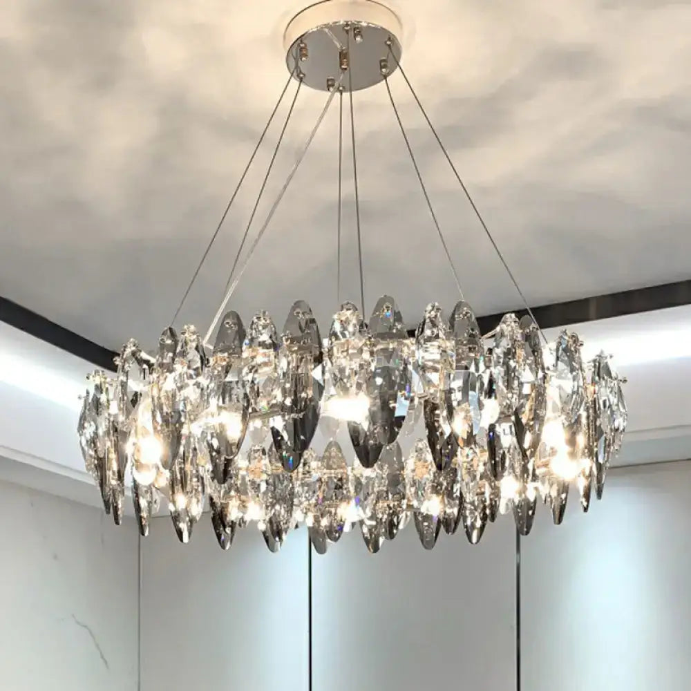 A modern minimalist oval crystal clear pendant chandelier with faceted teardrop crystals and chrome mount for 220v-240v use
